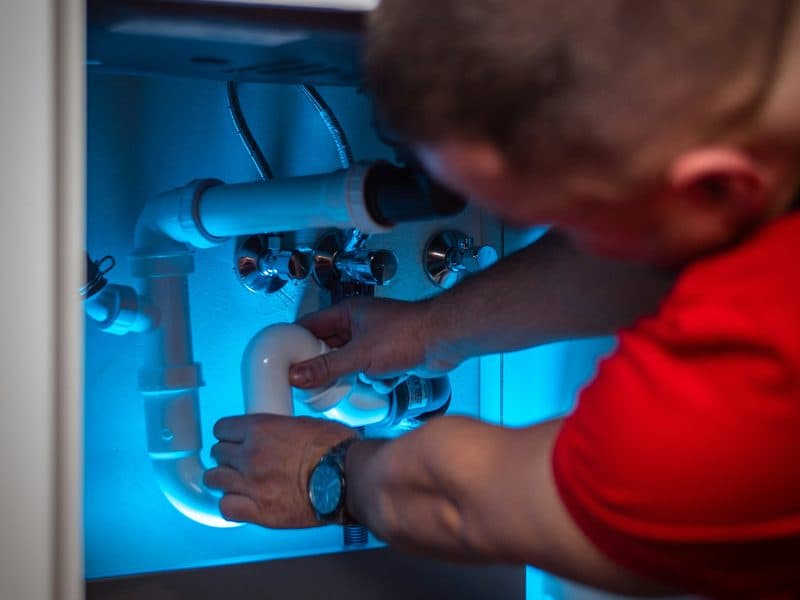 Plumber repairing a pipe