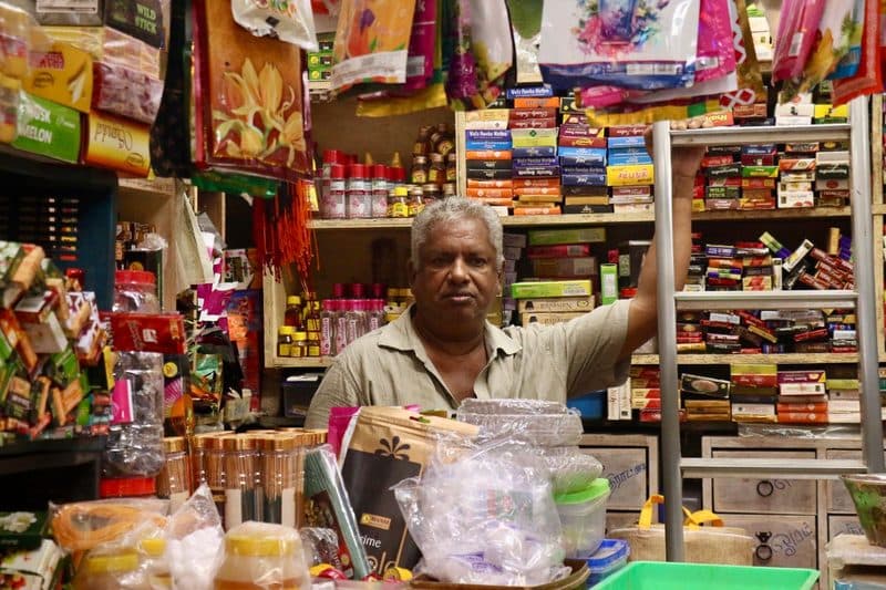Local shopkeeper at his store counter